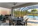 Covered patio with dining area overlooking a screened-in pool and backyard at 5709 Sunflower Cir, Sarasota, FL 34238