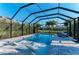 Stunning screened pool with relaxing lounge chairs, set amidst tropical plants and views of the landscaped backyard at 5709 Sunflower Cir, Sarasota, FL 34238