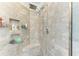 Modern shower with gray tile, rainfall showerhead, and built-in shelving at 5709 Sunflower Cir, Sarasota, FL 34238