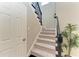 Carpeted staircase with black iron railing and white trim at 5709 Sunflower Cir, Sarasota, FL 34238