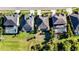 Aerial view showcasing several homes with well-manicured lawns and neighborhood landscaping at 5746 Hydrangea Cir, Sarasota, FL 34238