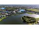 Aerial view of a community featuring luxury homes nestled along a picturesque lake and landscaped surroundings at 5746 Hydrangea Cir, Sarasota, FL 34238