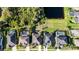 Neighborhood aerial view showcasing homes with private pools, lush landscaping, and stunning natural pond views at 5746 Hydrangea Cir, Sarasota, FL 34238