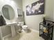 Powder room with a pedestal sink, a large map, and modern decor at 5746 Hydrangea Cir, Sarasota, FL 34238