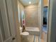 Bright bathroom featuring a tiled shower-tub combo and a window for natural light at 5746 Hydrangea Cir, Sarasota, FL 34238