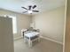 Bright bedroom featuring a ceiling fan, neutral paint and simple decor at 5746 Hydrangea Cir, Sarasota, FL 34238