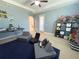 Spacious bedroom featuring a ceiling fan, blue accent wall, and playful decor at 5746 Hydrangea Cir, Sarasota, FL 34238