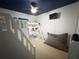 Fun bedroom featuring a loft bed with a star-painted ceiling and a comfortable beanbag chair at 5746 Hydrangea Cir, Sarasota, FL 34238