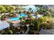 Resort-style community pool area featuring lush landscaping, sun loungers, and a splash zone for endless relaxation at 5746 Hydrangea Cir, Sarasota, FL 34238