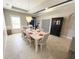 Bright dining room featuring a modern chandelier, a light wood table, and elegant decor at 5746 Hydrangea Cir, Sarasota, FL 34238