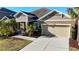 Attractive one-story home with 2 car garage, manicured lawn and tropical landscaping at 5746 Hydrangea Cir, Sarasota, FL 34238