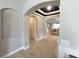 Hallway with archways and views of the living room, featuring tile floors and neutral paint at 5746 Hydrangea Cir, Sarasota, FL 34238