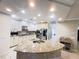 Modern kitchen with an island featuring granite countertops and stainless steel appliances at 5746 Hydrangea Cir, Sarasota, FL 34238