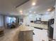Spacious kitchen with granite island, modern appliances, and adjacent dining area at 5746 Hydrangea Cir, Sarasota, FL 34238