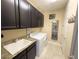 Functional laundry room with sleek cabinets, washing machine, and a utility sink at 5746 Hydrangea Cir, Sarasota, FL 34238