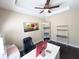Office with a ceiling fan, a painting, built-in shelves, and a white desk at 5746 Hydrangea Cir, Sarasota, FL 34238