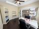 Well-lit office space with built-in shelving, a ceiling fan, and a view to the dining room at 5746 Hydrangea Cir, Sarasota, FL 34238