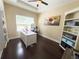 Bright office with hardwood floors, white desk, a ceiling fan, and natural light from the window at 5746 Hydrangea Cir, Sarasota, FL 34238