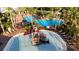 Aerial view of a community splash pad area with pirate-themed play equipment and a pool nearby at 5746 Hydrangea Cir, Sarasota, FL 34238