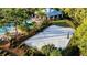 Community sand volleyball court surrounded by lush greenery, nearby the pool and outdoor recreation areas at 5746 Hydrangea Cir, Sarasota, FL 34238