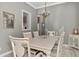 Dining room featuring white table and chandelier at 5916 Mariposa Ln, Sarasota, FL 34238