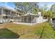 Spacious backyard featuring a screened porch, perfect for enjoying the outdoors at 6201 Waverly Rd, Weeki Wachee, FL 34607