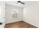 Cozy bedroom with a ceiling fan, a window for natural light, and wood-look flooring at 6201 Waverly Rd, Weeki Wachee, FL 34607