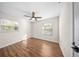 Inviting bedroom featuring hardwood floors, ample natural light, and neutral walls at 6201 Waverly Rd, Weeki Wachee, FL 34607