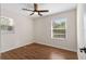 Bright bedroom with ceiling fan, wood-look floors, and natural light streaming through the windows at 6201 Waverly Rd, Weeki Wachee, FL 34607