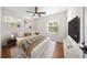 Well-lit bedroom boasts a large window, stylish furnishings and hardwood flooring at 6201 Waverly Rd, Weeki Wachee, FL 34607
