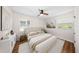 Bright bedroom featuring hardwood floors, a queen bed, and soothing decor at 6201 Waverly Rd, Weeki Wachee, FL 34607