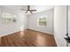 Bright bedroom featuring hardwood floors, natural light from windows and ceiling fan at 6201 Waverly Rd, Weeki Wachee, FL 34607