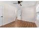 Cozy bedroom with wood-look flooring, ceiling fan, neutral walls and bright white trim at 6201 Waverly Rd, Weeki Wachee, FL 34607