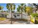 Lovely home exterior showcasing mature palms and an attractive privacy fence at 6201 Waverly Rd, Weeki Wachee, FL 34607
