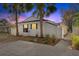 Charming exterior view of the home featuring tropical landscaping and a privacy fence at 6201 Waverly Rd, Weeki Wachee, FL 34607