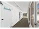Hallway leading to the screened in back porch with laundry room on the left at 6201 Waverly Rd, Weeki Wachee, FL 34607