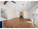 Spacious room boasts an airy feel with wood flooring, fireplace, and modern light fixtures at 6201 Waverly Rd, Weeki Wachee, FL 34607