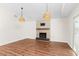 Spacious living room with a cozy fireplace and modern lighting fixtures at 6201 Waverly Rd, Weeki Wachee, FL 34607