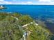 Beautiful aerial image of a private dock with a boat lift for accessing the Intracoastal Waterway at 691 Gulf Bay Rd, Longboat Key, FL 34228