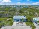 Property aerial shot of the house showing well-manicured lawns, mature trees, and neighborhood location at 691 Gulf Bay Rd, Longboat Key, FL 34228