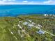 Overhead view of the property surrounded by trees and water, highlighting the beautiful neighborhood setting at 691 & 681 Gulf Bay Rd, Longboat Key, FL 34228