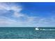 A motorboat speeding across the ocean with a beautiful skyline at 691 Gulf Bay Rd, Longboat Key, FL 34228