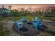 Backyard space with a fire pit surrounded by chairs and greenery, ideal for outdoor gatherings at 691 Gulf Bay Rd, Longboat Key, FL 34228