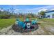 Backyard fire pit and patio seating area, offering a cozy outdoor entertainment space at 691 Gulf Bay Rd, Longboat Key, FL 34228