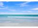 Beautiful beachfront view featuring clear turquoise water and a serene white sandy beach at 691 Gulf Bay Rd, Longboat Key, FL 34228