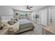 Cozy bedroom features a ceiling fan, and a window view of tropical foliage at 691 Gulf Bay Rd, Longboat Key, FL 34228