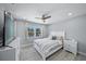 Bright bedroom with a ceiling fan, a window offering nice views, and a neatly made bed at 691 Gulf Bay Rd, Longboat Key, FL 34228