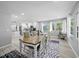 Elegant dining area with a large table, natural light, and open access to the kitchen at 691 Gulf Bay Rd, Longboat Key, FL 34228