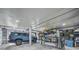 Spacious garage with ample storage, featuring a parked car and organized shelving units at 691 Gulf Bay Rd, Longboat Key, FL 34228