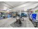 Organized garage space with workout equipment, car and storage shelving at 691 Gulf Bay Rd, Longboat Key, FL 34228